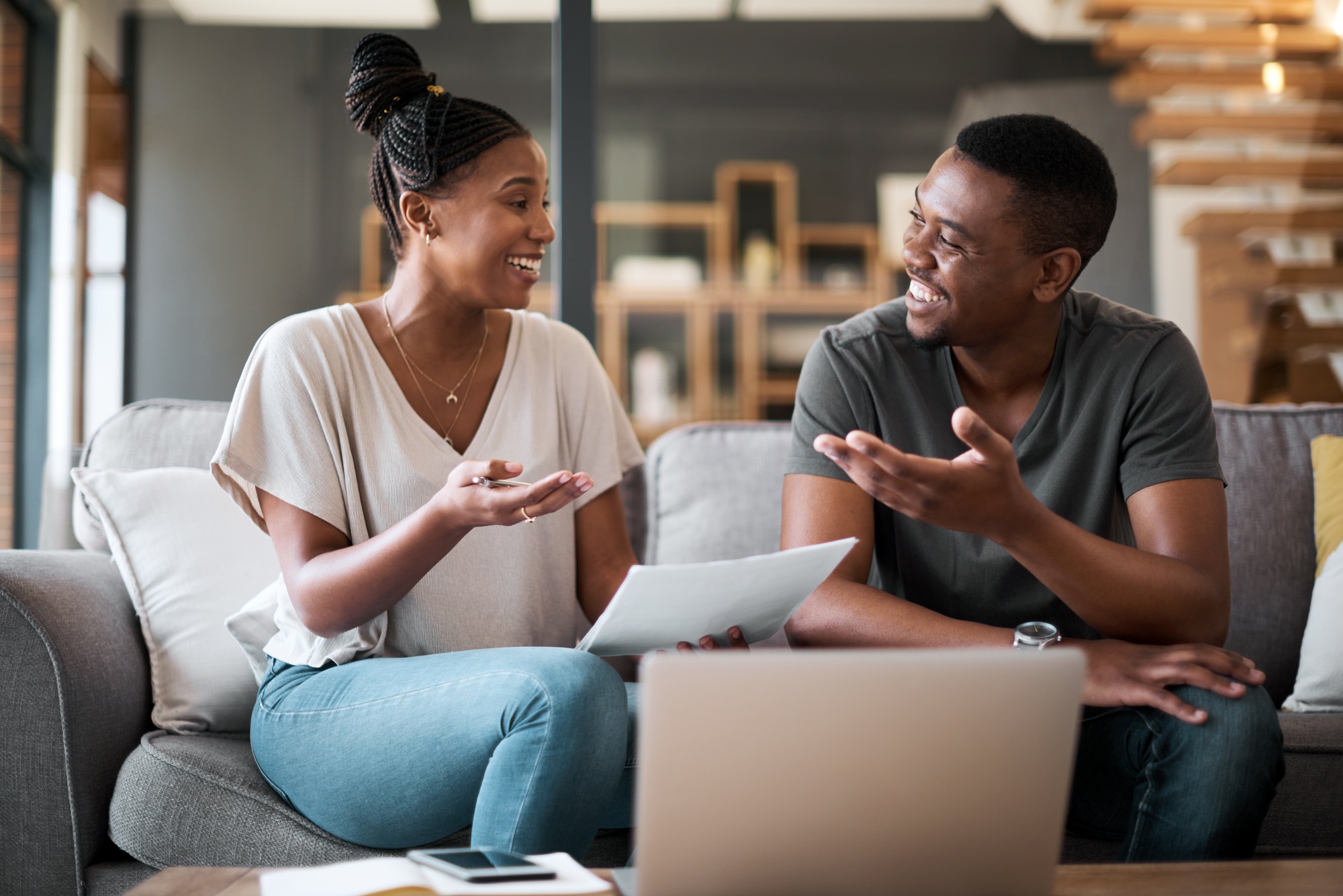 Shot of a young couple going through paperwork together at home